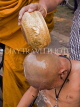 THAILAND, Northern Thailand, Mae Hong Son, novice monk's head washed after shaving, THA213