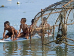 THAILAND, Phuket, Rawai Beach, sea gypsy children plaing with surfboard, by fish trap, THA2009JPL