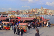 TURKEY, Istanbul, Eminonu Waterfront, food stalls and crowds, New City in background, TUR969JPL