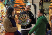 TURKEY, Istanbul, Grand Bazaar (Kapali Carsi), customers bargaining with vendor, TUR1292JPL