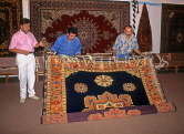 TURKEY, Istanbul, shopping, salesmen displaying hand woven carpets, TUR264JPL