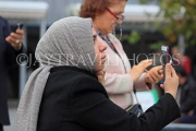 TURKEY, Istanbul, woman looking at her phone, TUR1403JPL