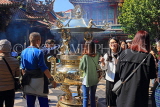 Taiwan, TAIPEI, Lungshan Temple, worshippers by incense burner censer, TAW663JPL