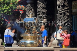 Taiwan, TAIPEI, Lungshan Temple, worshippers by incense burner censer, TAW668JPL