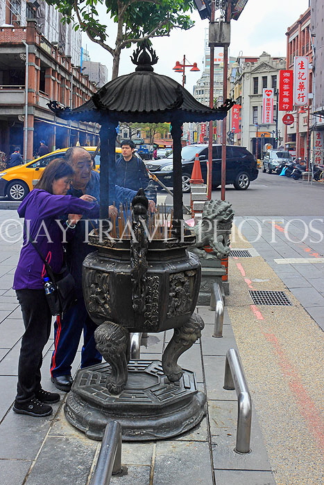 Taiwan, TAIPEI, Xia Hai City God Temple, worshippers at incense burner censer, TAW1312JPL
