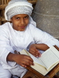 UAE, DUBAI, young boy reading the Koran, DUB189JPL