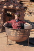 USA, California, Calico Ghost Town, old Chinese bath tub, and tourist sitting in it, US4849JPL