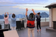 VIETNAM, Halong Bay, dawn, cruise boat, tourists practicing Tai Chi on board, VT1834JPL