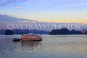 VIETNAM, Halong Bay, dawn, limestone formations and moored cruise boat, VT1820JPL