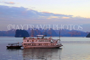 VIETNAM, Halong Bay, dawn, limestone formations and moored cruise boat, VT1821JPL