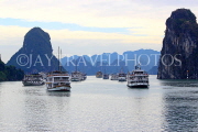 VIETNAM, Halong Bay, moored cruise boats, and limestone formations, VT1830JPL
