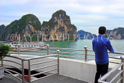 VIETNAM, Halong Bay, tourist viewing the scenery from cruise boat, VT1868JPL