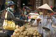 VIETNAM, Hanoi, market scene, vendor selling yams, VT563JPL