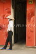 VIETNAM, Hanoi, woman by red wall, VT598JPL