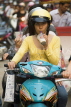 VIETNAM, Hanoi, woman having drinking, while riding motorbike, VT599JPL