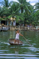 VIETNAM, Hoi An, Thu Bon River, man in small boat and riverside houses, VT155JPL