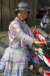 VIETNAM, Lao Cai province, Sapa, Black Hmong trobe gilr on bike, VT618JPL