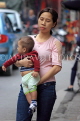 Vietnam, HANOI, Old Quarter, mother walking along road carrying toddler, VT1422JPL