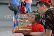 Vietnam, HANOI, child with pet bird in cage (from Bird Market), VT1761JPL