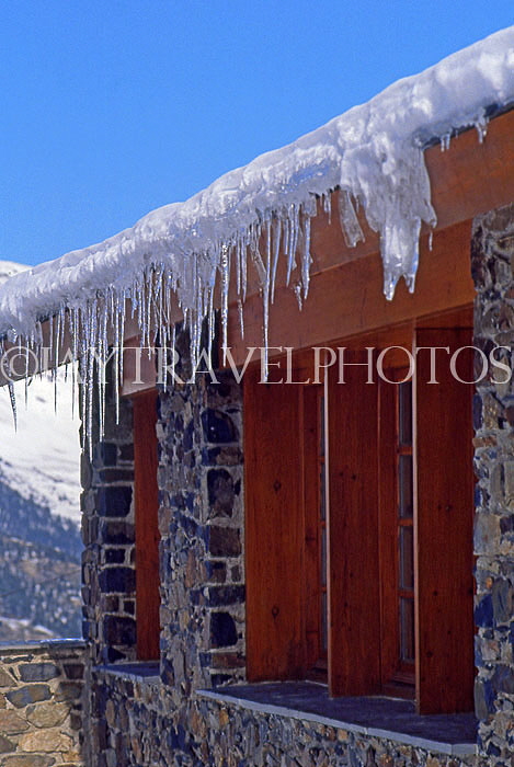 AUSTRIA, Tyrol, Zillertal, Alps scenery, icicles on log cabin and paraglider, AST554JPL