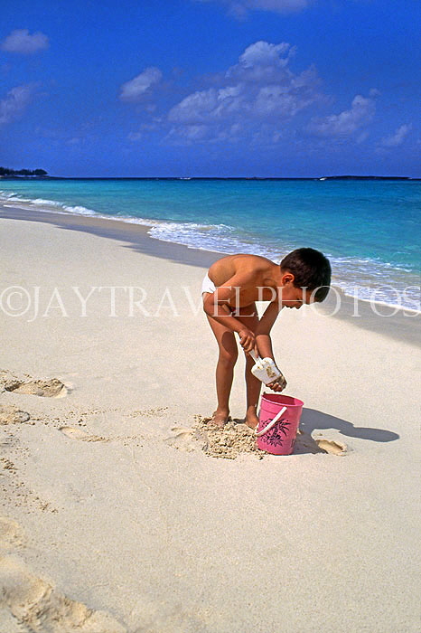 BAHAMAS, Paradise Island, boy with bucket, playing on beach, BAH263JPL