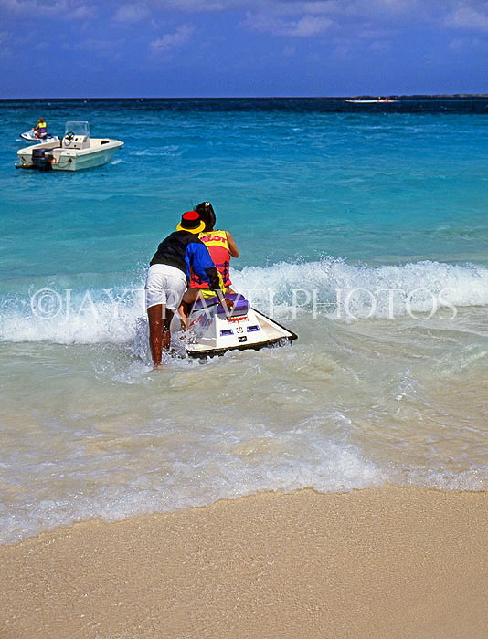 BAHAMAS, Paradise Island, tourist preparing for water scooter ride, BAH378JPL