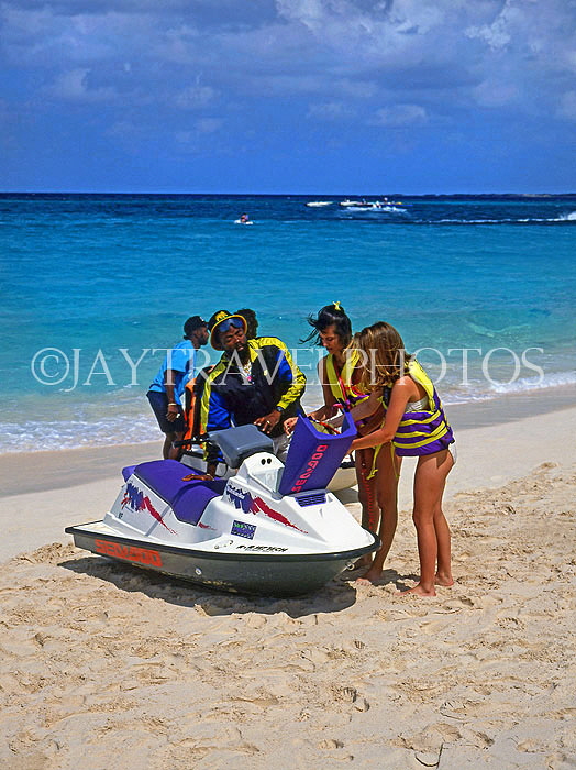 BAHAMAS, Paradise Island, tourists preparing for water scooter ride, BAH375JPL