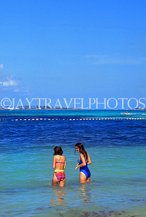BAHAMAS, Paradise Island, two women walking into sea to swim, BAH231JPL