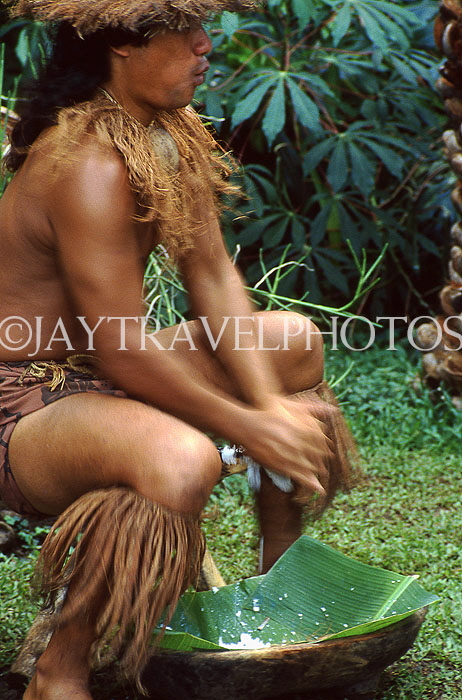 COOK ISLANDS, Rarotonga, Cultural Village, Maori man demonstrating coconut scraping, CI182JPL