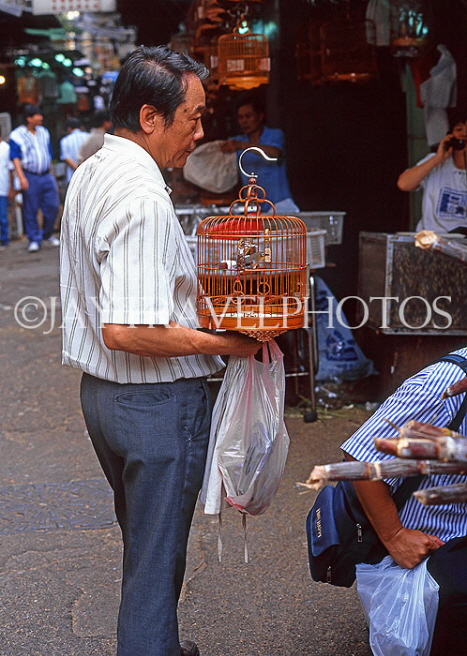 HONG KONG, Kowloon, Mong Kok, Yuen Po Street Bird Market, customer with bird cage, HK293JPL