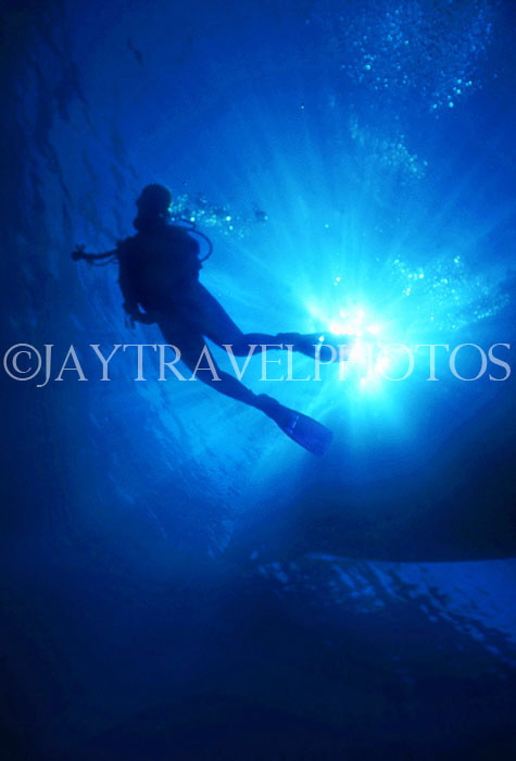 MALDIVE ISLANDS, scuba diver, silhouetted against sun shining through sea, MAL582JPL