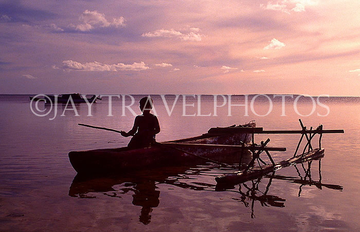 TONGA, Atata Island, Tongan boy in catamaran, dusk, TON195JPL