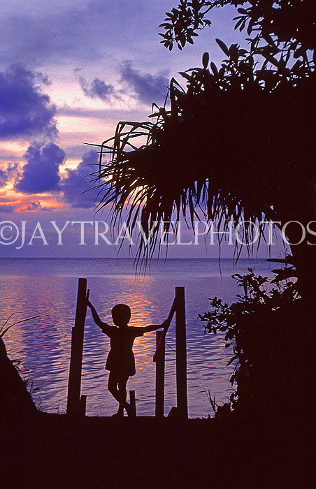 TONGA, Atata Island, sea view at sunset, and small boy, TON168JPL